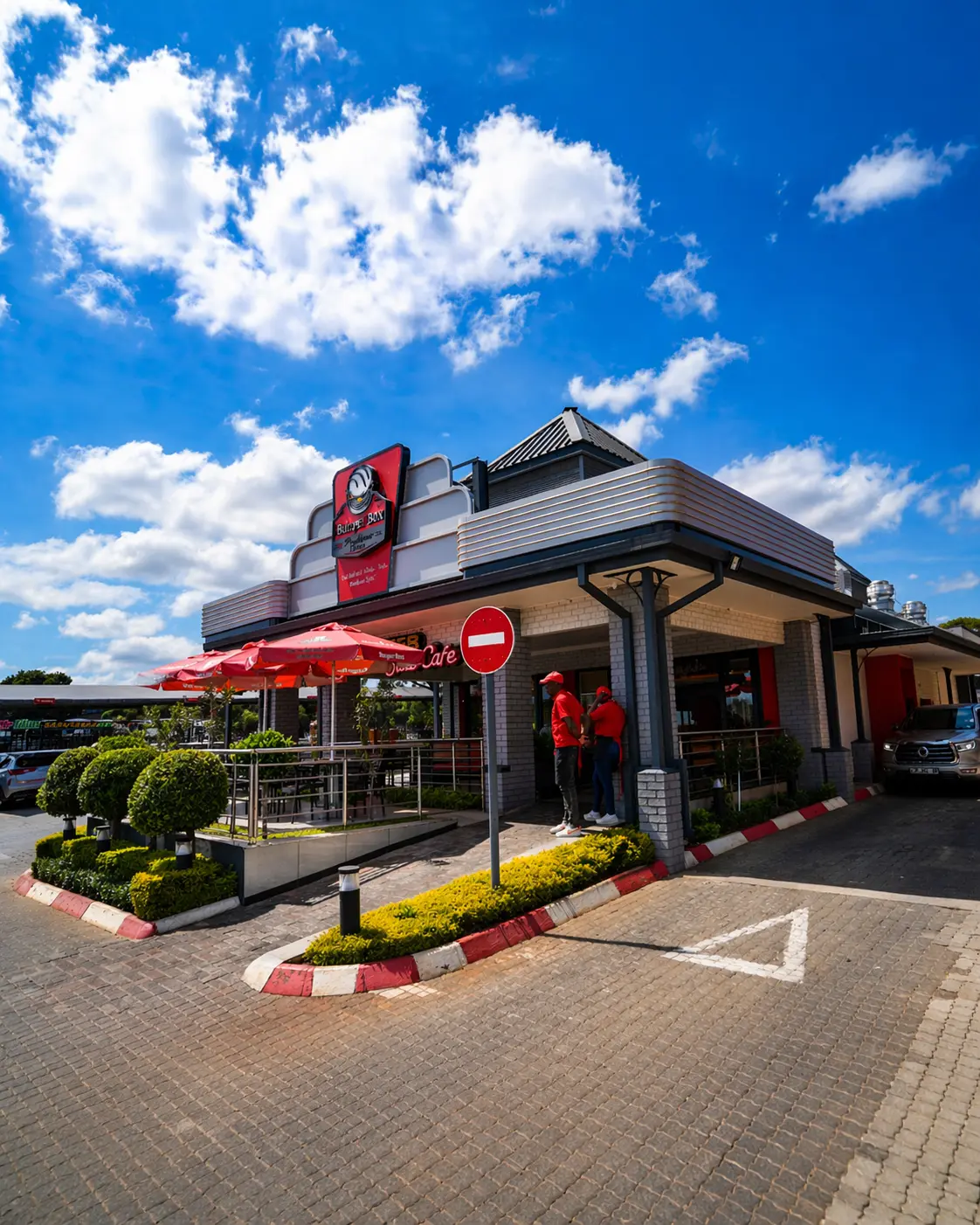Exterior view of a Burger Box Roadhouse and Diner branch building on a sunny day