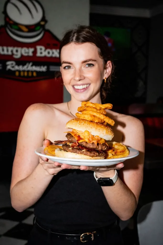Women holding a Loaded burger from Burger Box