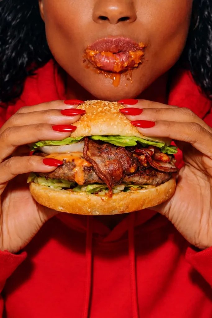 A woman holding a delicious burger from Burger Box